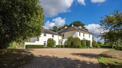 The house is at the end of a long tree-lined drive
