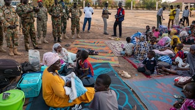 Senior officials of the South Sudan People's Defence Forces visit Sudanese nationals seeking safety at the army headquarters after a night of violence in Juba, South Sudan, on Friday. AP