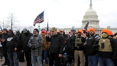 Proud Boys member Joe Biggs poses with other members before he was later arrested for involvement in the storming of the US Capitol building in Washington DC. Reuters