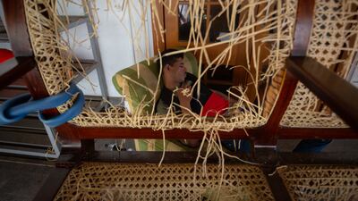 A protester sleeps on vandalised furniture inside the presidential palace in Colombo, which has been occupied by demonstrators for days. Getty Images