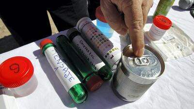 Chile's Health Minister Jaime Manalich points to a canister containing a special food that will be sent to the 33 miners, August 24, 2010. Rescuers sent Chilean miners still alive 18 days after a cave-in supplies of saline and glucose through a narrow drill hole on Monday, and now face a months-long, half-mile dig to save them. REUTERS