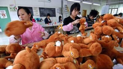 Chinese workers stitch teddy bears, at the PP Bear Toy Company located in the southern Chinese city of Shenzhen.