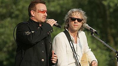 Irish singers Bono and Bob Geldof perform during a concert in Germany. A reader suggests that they turn their attention to the Irish debt crisis.