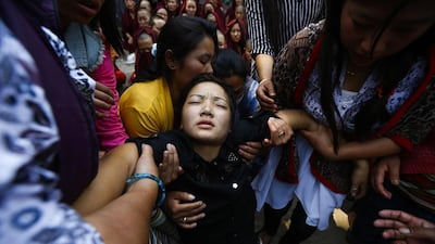Daughter of Ang Kaji Sherpa, one of the victims of the Mount Everest avalanche on 18 April, collapses during a cremation ceremony at Syambhu in Kathmandu, Nepal. Narendra Shestha / EPA