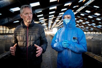 Denmark's Prime Minister Mette Frederiksen, right, was teary after visiting mink breeder Peter Hindbo' farm. EPA