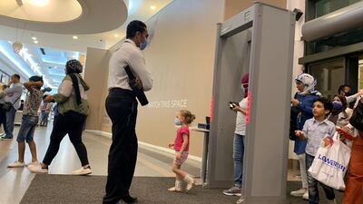 A security personnel looks at shoppers entering a Carrefour hypermarket in the Cairo suburb of Maadi, Egypt. Reuters