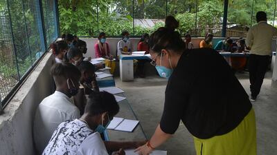 Young people attend a class organised by an Indian couple for underprivileged pupils who cannot access online classes in Hatighisa village in West Bengal.
