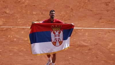 Novak Djokovic celebrates with a Serbian flag after beating Spain's Carlos Alcaraz. AFP