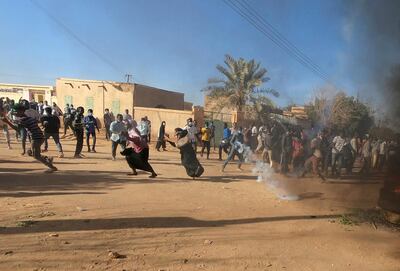 Sudanese demonstrators run from a teargas canister fired by riot police in Omdurman, Khartoum on January 20. Reuters