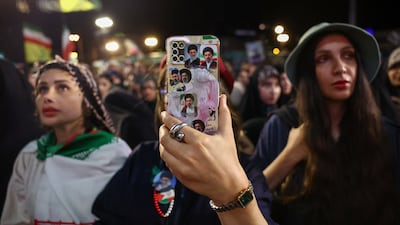 A phone with stickers of Iranian Supreme Leader Mojtaba Khamenei and his father, the late Supreme Leader Ayatollah Ali Khamenei, at a farewell ceremony for Iran's national soccer team ahead of their departure to the 2026 World Cup, in Tehran. Reuters