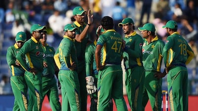 Pakistan celebrate a wicket during the second one day international match against England at Zayed Cricket Stadium in Abu Dhabi, United Arab Emirates, Friday, Nov. 13, 2015. (AP Photo/Hafsal Ahmed)