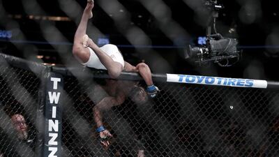 Yoel Romero jumps out of the ring after knocking out Chris Weidman. Julio Cortez / AP Photo