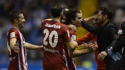 Atletico Madrid's Tiago, left, celebrates with Argentinian coach Diego Simeone, right, after scoring a goal during the Spanish league football match RC Deportivo La Coruna vs Club Atletico de Madrid at the Municipal de Riazor stadium in La Coruna on October 30, 2015. AFP PHOTO / MIGUEL RIOPA