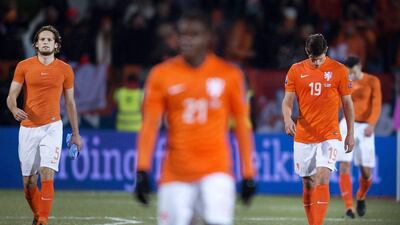 Daley Blind, left, and Klaas-Jan Huntelaar, right, of the Netherlands walk off the pitch following their 2-0 loss to Iceland on Monday night in Reykjavik in Euro 2016 qualifying. Olaf Kraak / EPA / October 13, 2014