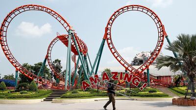 A worker walks past an empty amusement ride at Siam Amazing Park, in Bangkok, Thailand. EPA