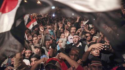 Egyptians celebrate the resignation of former president Hosni Mubarak in Tahrir Square in February 2011 / AP