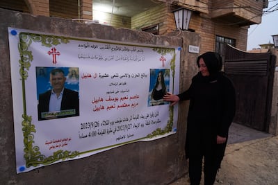 Maryam Moatasem's mother looks at a condolence banner for her daughter, who died in the wedding hall fire in Qaraqosh, Iraq. Ismael Adnan for The National