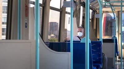A man wearing a face mask on an almost empty train in East London. PA