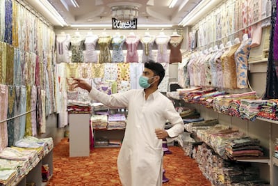 Imran Khan from Pakistan works at Zahrat Al Banafsaj garments shop. Pawan Singh / The National