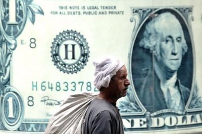A man walks past the window of an exchange bureau in Cairo, Egypt. AP