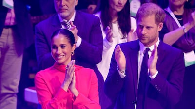 Meghan, Duchess of Sussex, pairs a red blouse and trousers by Another Tomorrow to attend the One Young World Summit 2022 with Prince Harry in Manchester, England on September 5. Getty