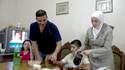 Syrian refugee Talal Al Tinawi, his wife Ghazal and their children Yara and Riad, pictured here at their home in Sao Paulo, are some of the few thousand Syrians to have travelled to Brazil. Nelson Almeida/AFP Photo