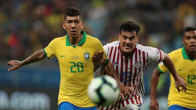 Firmino and Paraguay's Gustavo Gomez eye the ball. AP Photo