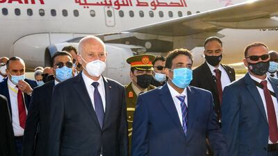 Tunisian President Kais Saied (L) received upon his arrival by Libya's new Head of the Presidential Council, Mohammad Menfi (2-R), in the Libyan capital Tripoli. AFP