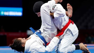 Jessa Khan of Cambodia and the UAE's Mahra Al Hanaei in action during the women’s 49kg final. Issei Kato / Reuters