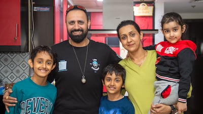 Manjeet Singh Gill with his wife Priyanka, and their children Armaan, Ivaan and Mannat, at their apartment in Dubai Sports City. All photos: Ahmed Ramzan for The National