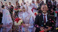 Palestinian couples participate in a mass wedding ceremony in Hamad City in Khan Younis, Gaza Strip, Tuesday, Dec. 2, 2025. (AP Photo / Abdel Kareem Hana)