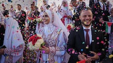 Palestinian couples participate in a mass wedding ceremony in Hamad City in Khan Younis, Gaza Strip, Tuesday, Dec. 2, 2025. (AP Photo / Abdel Kareem Hana)