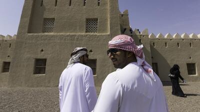 Emirati men and women walk through the Bin Hammoodah Al Dhaheri house, in the Jimi Oasis, during the first, ‘My Old House’ tour, a new cultural walking tour that has been launched by the Abu Dhabi Tourism & Culture Authority, in Al Ain. The original Al Dhaheri house is believed to be more than 200 years old. Christopher Pike / The National