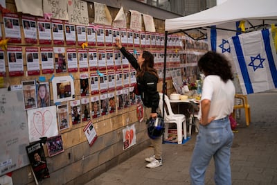 A friend of Hersh Goldberg-Polin, who was abducted during a Hamas attack on Israel, touches his photograph in Tel Aviv, Israel. AP Photo