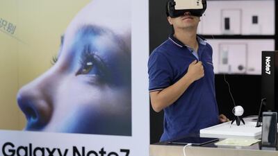 A man tries out the Samsung VR using its Galaxy Note 7 smartphone, which the company is recalling worldwide. Today China joined the list even though Samsung had said those phones used different batteries from the affected ones. Andy Wong / AP