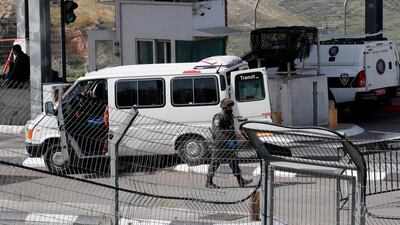 An Israeli border guard walks past the vehicle of a Palestinian man who attacked Israeli security forces at a checkpoint and was subsequently shot dead in the occupied West Bank. The incident occurred on April 22, 2020, between the village of Abu Dis and the town of Bethlehem. AFP