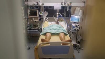 The patient in room No. 10, is pictured hours before he died after his nearly month-long battle against COVID-19 at Bichat Hospital, AP-HP, in Paris Tuesday, Dec. 1, 2020. The patient in room No. 10 died on Dec. 1. His was one of 775 virus deaths in France that day, adding to a national death toll now topping 56,000 and the worldwide count of more than 1.5 million dead. (AP Photo/Francois Mori)
