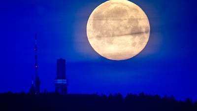 The moon is seen over the top of the Feldberg mountain near Frankfurt, Germany, early Saturday, May 6, 2023. (AP Photo / Michael Probst)
