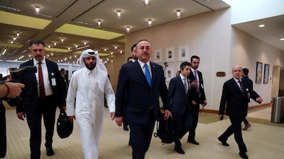 Turkish Foreign Minister Mevlut Cavusoglu walks ahead of the signing of an agreement between members of Afghanistan's Taliban delegation and the US government in Doha, Qatar. Reuters