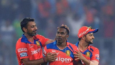 Dwayne Bravo, centre, and Gujarat Lions teammates Praveen Kumar, left, and Suresh Raina celebrate after their win on Wednesday night in the Indian Premier League. Sajjad Hussain / AFP / April 27, 2016