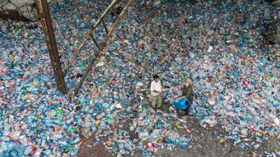 Musicians Roni Aran and Herman Artuc, members of the ethnic instrumental music band of Fungistanbul, perform with instruments made by materials collected from landfills, at a recycling depot in Istanbul, Turkey. Reuters