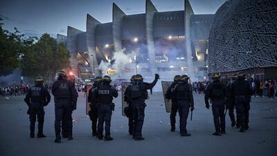 French Riot police face PSG fans during confrontation outside Parc de Princes stadium. Getty