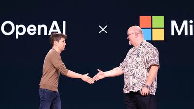 OpenAI chief executive Sam Altman, left, shakes hands with Microsoft chief technology officer Kevin Scott at a conference at Microsoft headquarters in May, AFP