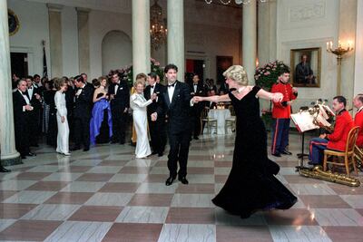 Princess Diana dances with John Travolta in Cross Hall at the White House during an official dinner in 1985 in Washington. Getty Images