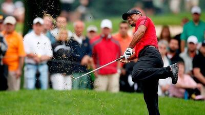 Tiger Woods hits out of the rough on the second hole during the final round in Ohio, but could not complete the round. Gregory Shamus / Getty Images