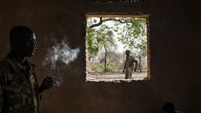A Sudan People’s Liberation Army (SPLA) government soldier from the 2nd Battalion smokes a cigarette at the SPLA headquarters in Nyang, in the county of Yirol East, South Sudan, on February 15, 2014. Fighting between forces loyal to South Sudanese president Salva Kiir and former vice president Riek Machar erupted on last December, sparking heavy clashes across the country that have left thousands dead and displaced close to 900,000 people. Fabio Bucciarelli / AFP photo