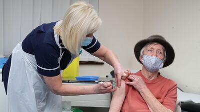 Practice Sister Tina Sutton administers a dose of the AstraZeneca/Oxford Covid-19 vaccine to Pat Hier at the Pontcae Medical Practice in Merthyr Tydfil in south Wales. AFP