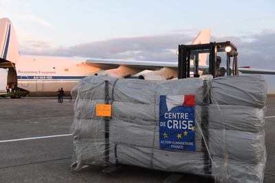 A forklift moves humanitarian supplies to be loaded onto Russian military officer stands by as an Antonov An-124 Ruslan-Widebody at the former Chateauroux-Deols Marcel Dassault Airport in central France. AFP
