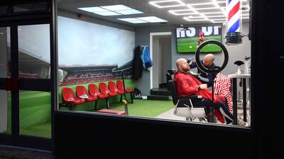 A man gets a shave at a football-themed barber shop near Nottingham Forest's ground, ahead of their English Premier League match against Manchester United. AFP