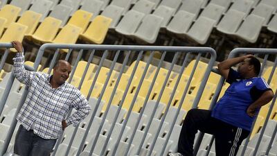 Zamalek club members react amidst the empty stands on Tuesday during their team's Egyptian Premier League loss to Al Ahly. Amr Abdallah Dalsh / Reuters